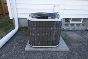 image of an old air conditioning unit that needs an cooling system replacement