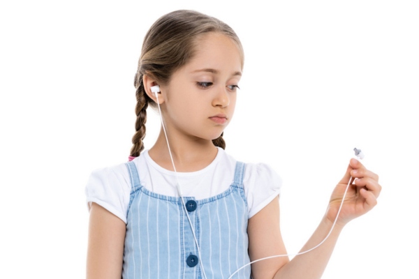 young girl looking at broken earphones depicting no sound